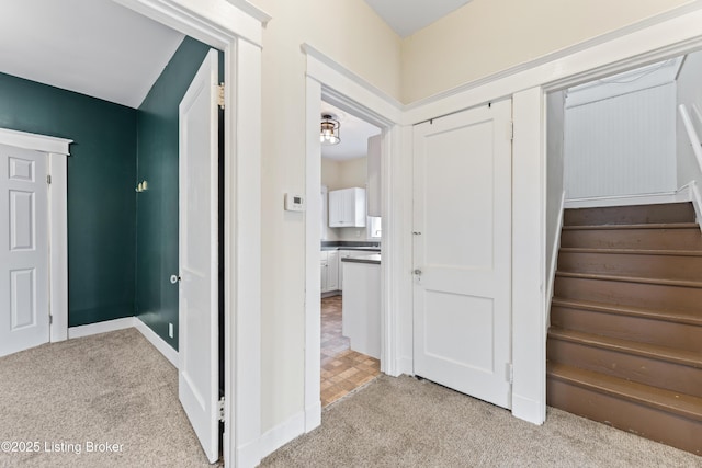 interior space with baseboards and carpet