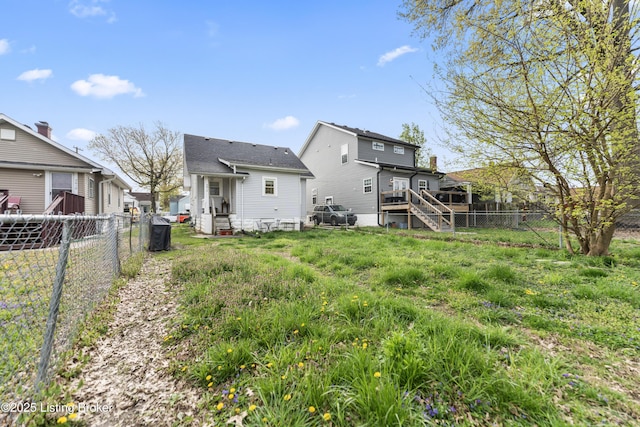 rear view of property with a fenced backyard