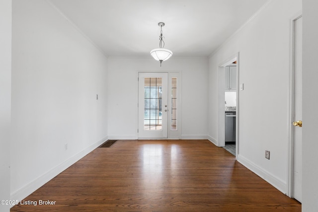 109 Ridgeway Ave, Louisville, KY 40207 - unfurnished dining area featuring dark wood-type flooring, ornamental molding, and baseboards