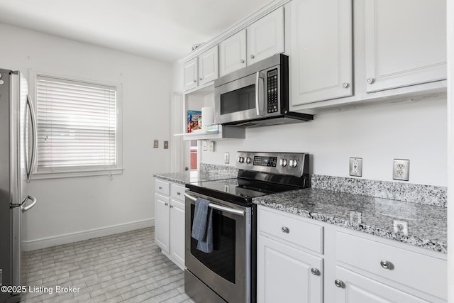 109 Ridgeway Ave, Louisville, KY 40207 - kitchen featuring appliances with stainless steel finishes, white cabinetry, baseboards, and light stone countertops