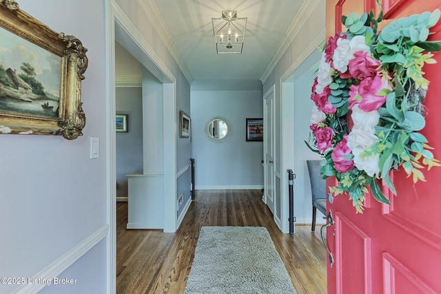 interior space featuring wood finished floors, a notable chandelier, and crown molding