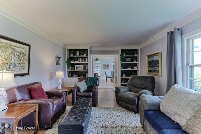 living area featuring ornamental molding, built in features, and light wood-style floors