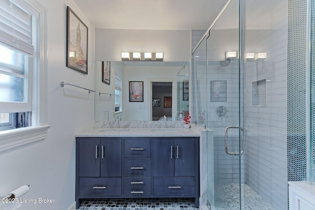 full bath with a wealth of natural light, a sink, and a stall shower