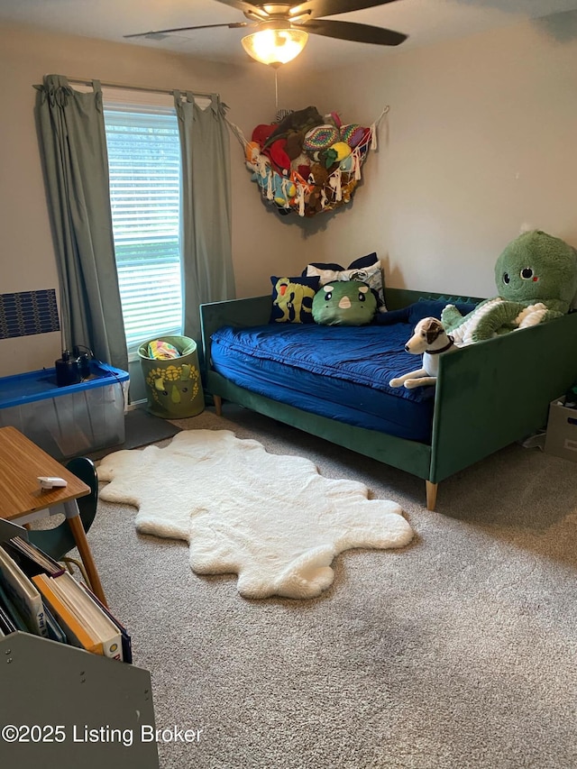 bedroom with a ceiling fan and carpet flooring