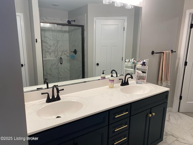 bathroom with marble finish floor, a stall shower, and a sink
