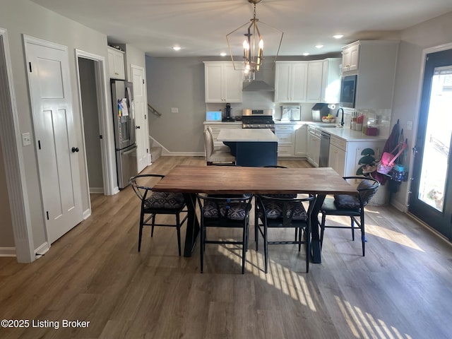 dining space featuring recessed lighting, baseboards, stairway, and light wood-type flooring