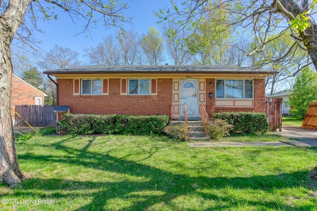 4311 Kurtz Ave, Louisville, KY 40229 - view of front of house with fence, brick siding, and a front yard