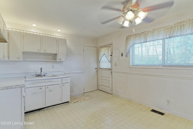 4311 Kurtz Ave, Louisville, KY 40229 - kitchen with light floors, light countertops, a sink, and a ceiling fan