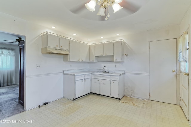 4311 Kurtz Ave, Louisville, KY 40229 - kitchen with a sink, light floors, ceiling fan, light countertops, and under cabinet range hood