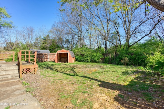 4311 Kurtz Ave, Louisville, KY 40229 - view of yard featuring fence, a storage unit, an outbuilding, and a deck