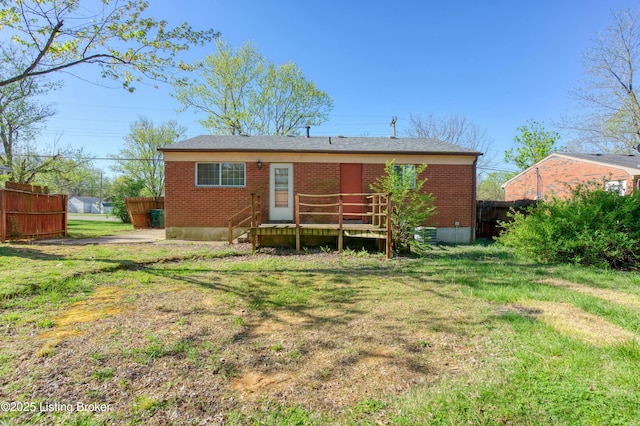 4311 Kurtz Ave, Louisville, KY 40229 - rear view of house with fence, a lawn, and brick siding