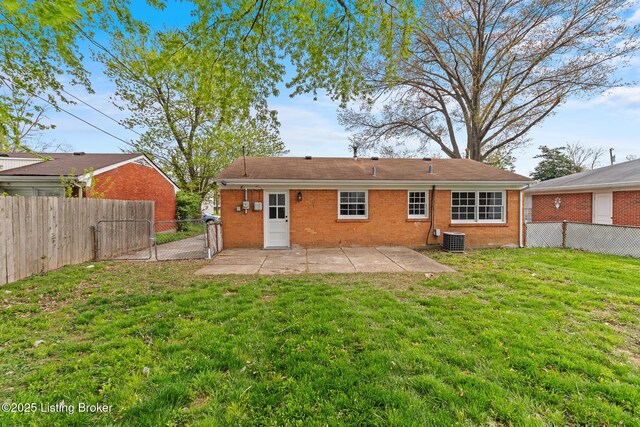 back of house with a fenced backyard, a patio, a lawn, and brick siding