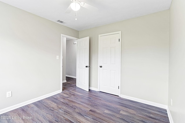 unfurnished bedroom featuring baseboards, a ceiling fan, wood finished floors, and visible vents