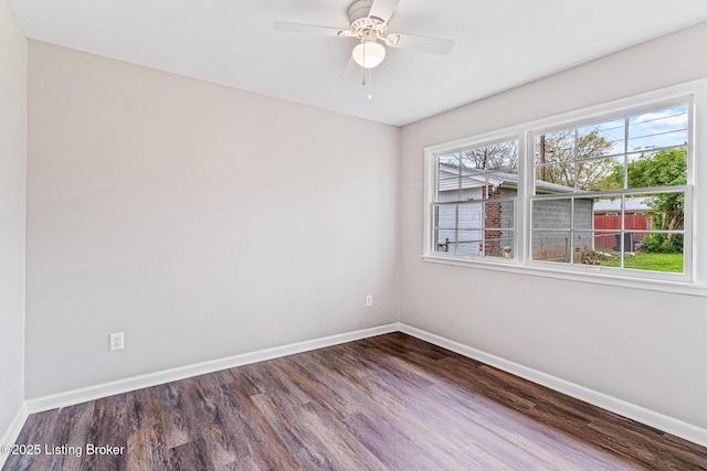 empty room featuring baseboards, a ceiling fan, and wood finished floors