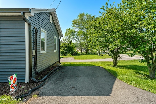 view of property exterior with a lawn