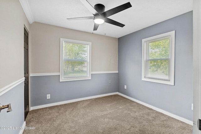 unfurnished room featuring healthy amount of natural light, ceiling fan, and carpet floors