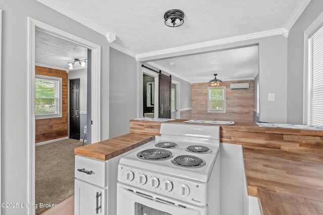 kitchen with electric stove, a textured ceiling, wooden counters, white cabinets, and a wall mounted AC