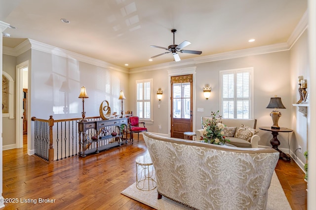 living area featuring baseboards, recessed lighting, a ceiling fan, ornamental molding, and wood-type flooring