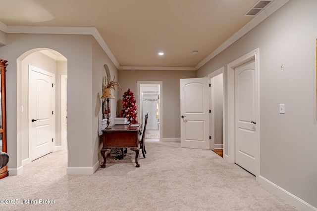 carpeted office featuring recessed lighting, visible vents, ornamental molding, arched walkways, and baseboards