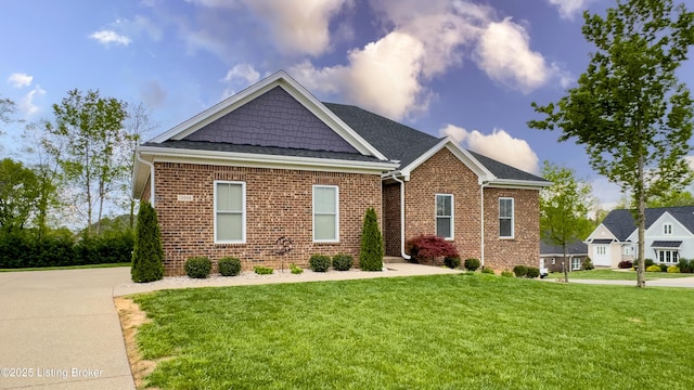 view of front of home with a front yard and brick siding