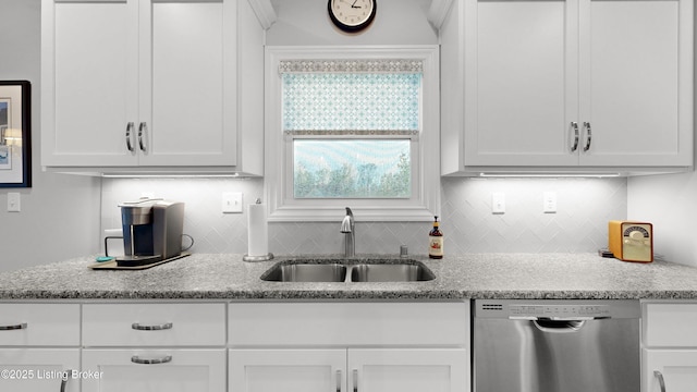 kitchen featuring white cabinetry, tasteful backsplash, dishwasher, and a sink