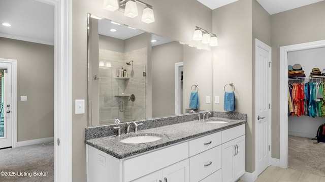 bathroom featuring double vanity, a sink, and a shower stall