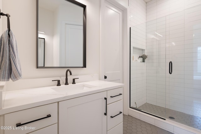 full bath with a shower stall, vanity, and tile patterned flooring