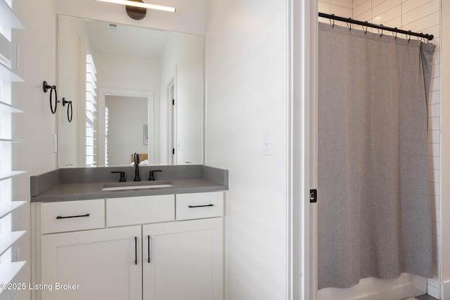 bathroom featuring vanity and a shower with shower curtain