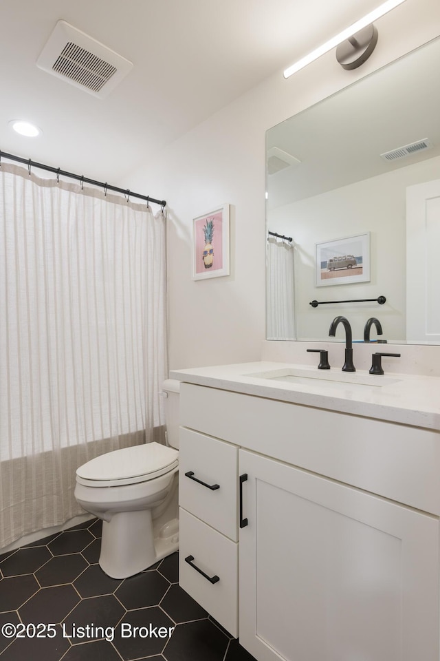full bathroom with tile patterned flooring, visible vents, toilet, and vanity