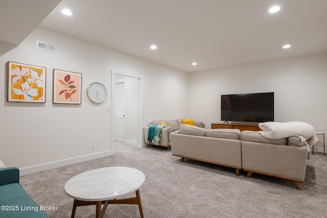 carpeted living area featuring baseboards, visible vents, and recessed lighting