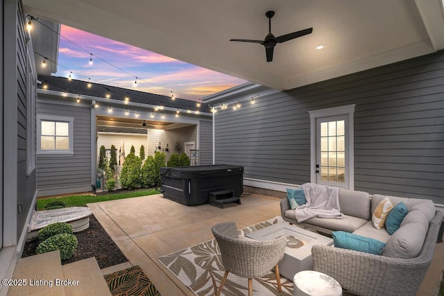 view of patio / terrace with ceiling fan, an outdoor hangout area, and a hot tub