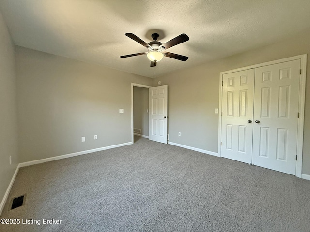 unfurnished bedroom featuring baseboards, visible vents, a closet, and carpet flooring