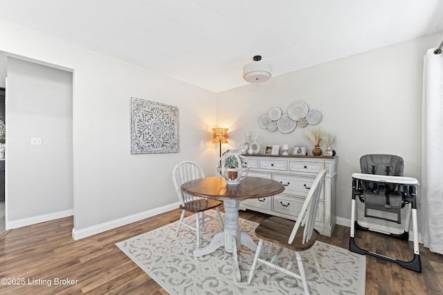 dining area featuring wood finished floors and baseboards
