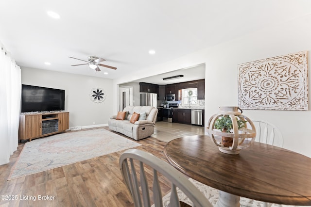 dining room featuring baseboards, recessed lighting, light wood-style floors, and ceiling fan