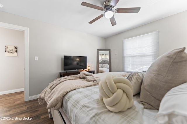 bedroom featuring dark wood finished floors, baseboards, and ceiling fan