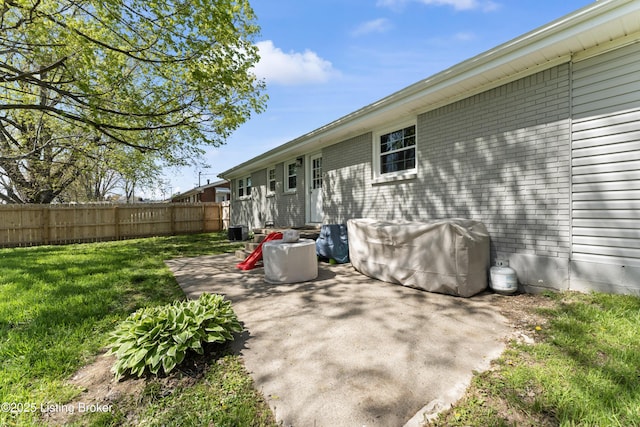 view of patio with grilling area, central air condition unit, and fence