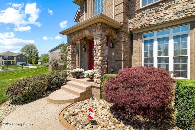 view of exterior entry featuring stone siding
