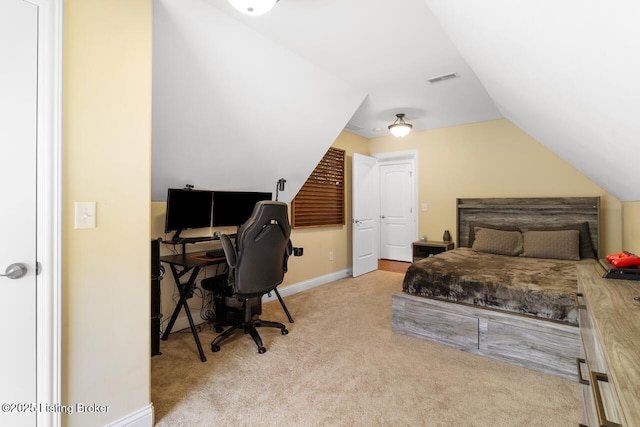 carpeted bedroom with lofted ceiling, baseboards, and visible vents