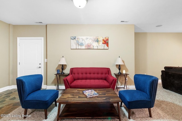 living room with baseboards and visible vents