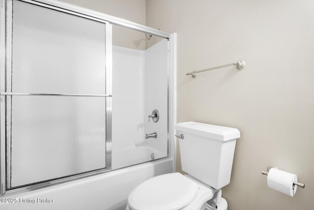 bathroom featuring toilet and enclosed tub / shower combo