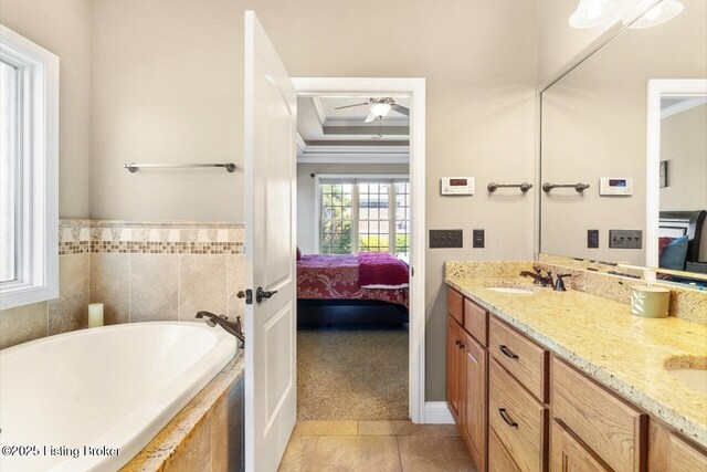 ensuite bathroom with a sink, ornamental molding, tile patterned flooring, double vanity, and connected bathroom