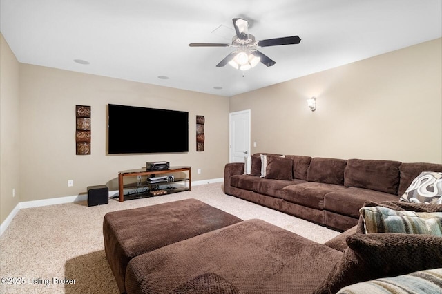 living area with baseboards, light carpet, and a ceiling fan