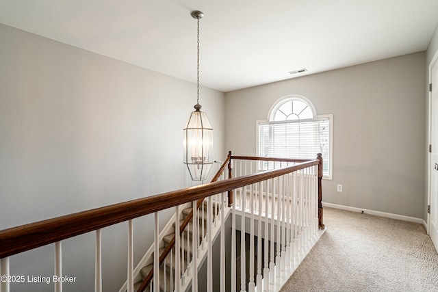 8805 Eli Dr, Louisville, KY 40291 - hallway featuring an upstairs landing, carpet, baseboards, a notable chandelier, and visible vents