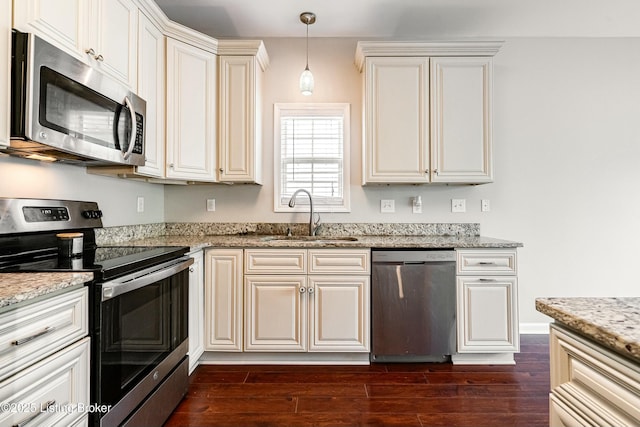 8805 Eli Dr, Louisville, KY 40291 - kitchen with a sink, appliances with stainless steel finishes, decorative light fixtures, dark wood-style flooring, and light stone countertops