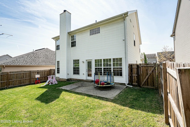8805 Eli Dr, Louisville, KY 40291 - back of house with a lawn, a fenced backyard, a chimney, and a patio