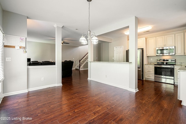 8805 Eli Dr, Louisville, KY 40291 - kitchen with dark wood finished floors, open floor plan, stainless steel appliances, and ceiling fan with notable chandelier