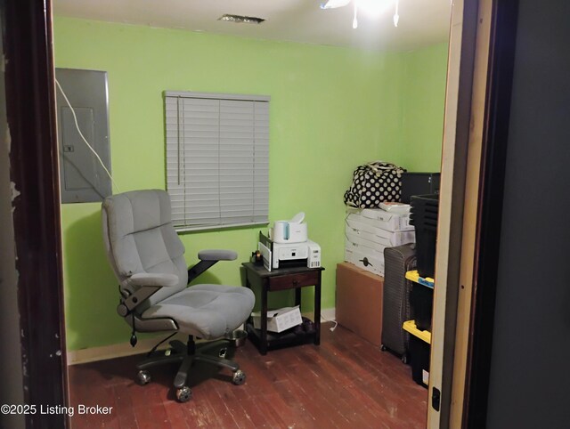 office area with baseboards, wood finished floors, and visible vents