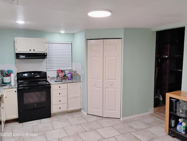 kitchen with white cabinetry, under cabinet range hood, black range with electric stovetop, and light tile patterned floors