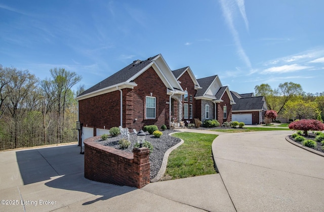 view of front of property featuring brick siding, an attached garage, and driveway
