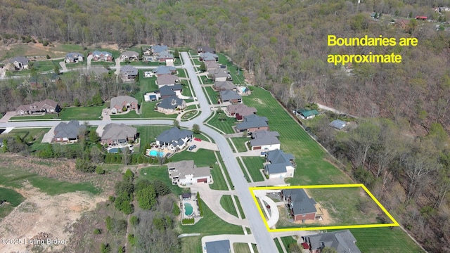 aerial view with a residential view and a wooded view